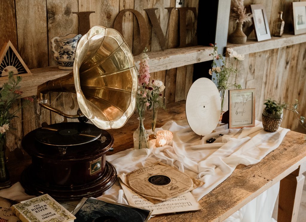 Musical gift table with gramophone and vinyl records for guests to sign.