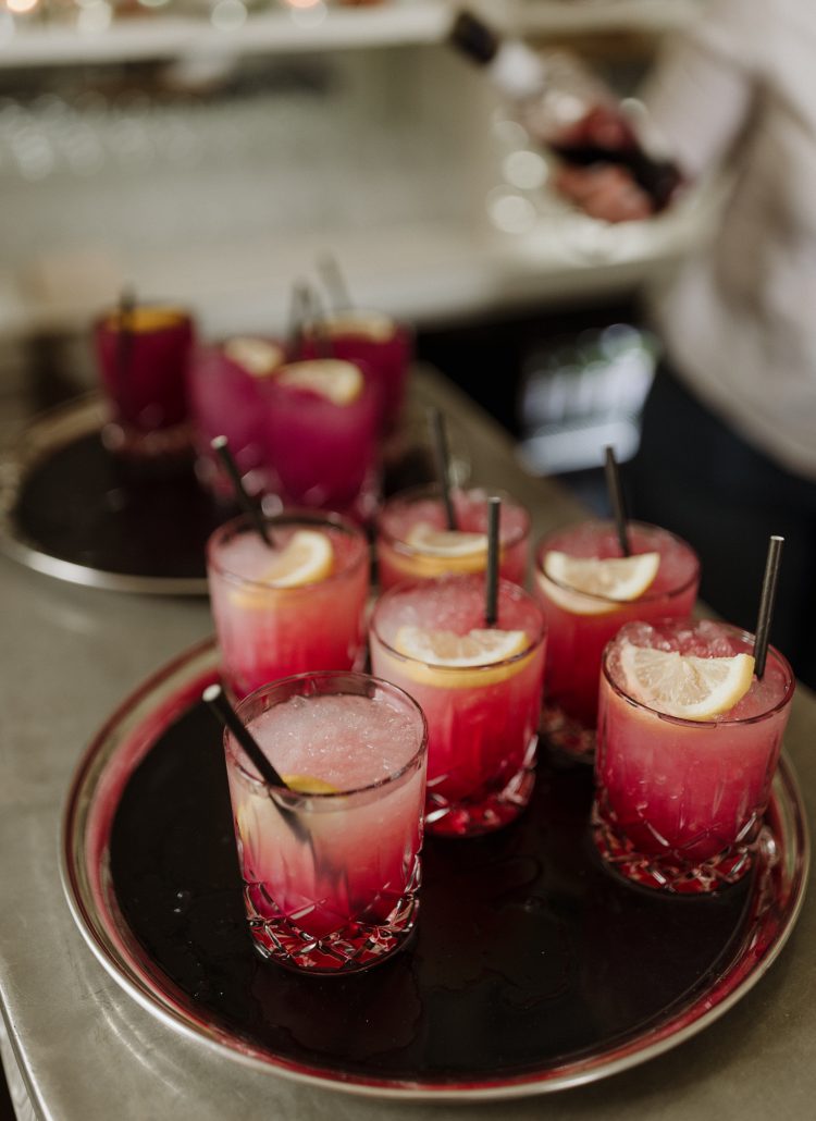 A tray of red berry bramble cocktails ready to be served to guests during the drinks reception at Middleton Lodge.