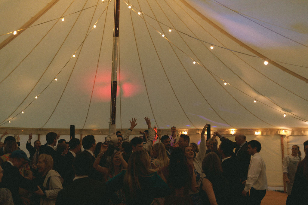 Planning your wedding music: 8 things you need to know. A canvas marquee full of guests dancing on the dancefloor as the band perform.
